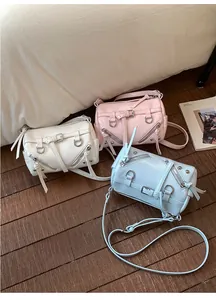 Three mini Boston baguette bags in white, pink and blue with textured PU leather finish