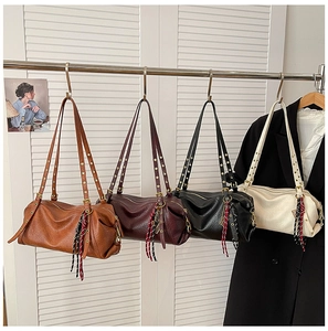 Litchi pattern leather cylinder bags in four colors with fringe tassel zipper details