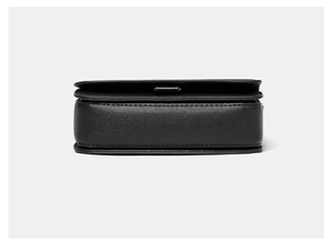 Detail view of the textured black leather base and stitching on this small square bag