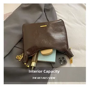 Detail view of the brown leather shoulder bag interior showing internal storage capacity