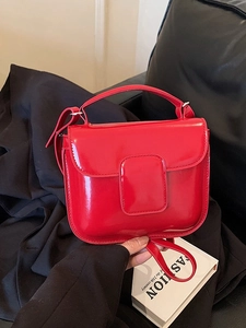 Elegant red oil wax leather handbag with glossy finish and top handle for women