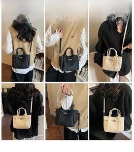 Détails du sac seau en cuir litchi avec fermoir tournant métallique et bandoulière
