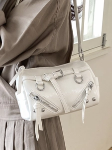 White cylinder motorcycle tote bag with rivet details and Y2K metallic punk style