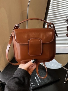 Polished brown oil wax leather handbag with top handle and adjustable shoulder strap