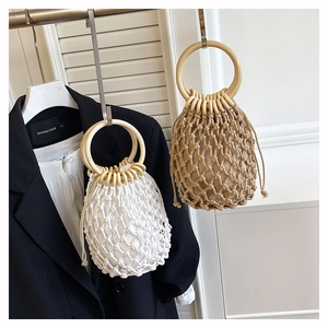 Detail of woven mesh tote bag with wooden ring handles and canvas drawstring lining