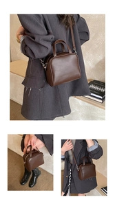 Detailed view of the dark brown leather handbag with adjustable crossbody strap and dual handles