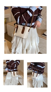 Detail of a beige mini bucket bag with dark brown handles and colorful bead charms