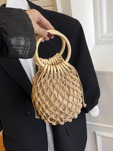 Handmade woven cotton rope tote bag with large circular wooden handles in cream white