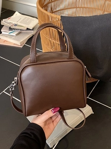 Minimalist deep brown square crossbody bag with dual top handles and smooth leather finish