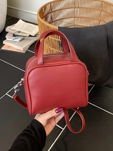 Minimalist red square tote bag with dual handles and silver zipper for daily commute