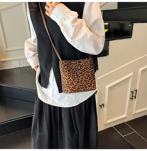 Gros plan d'un sac à bandoulière léopard porté par un mannequin de mode chic