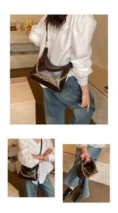 Detailed views of dark brown glossy leather dumpling bag with gold chunky chain strap