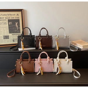 Mini handbags in six colors featuring crinkled texture, knot handles and beaded tassels