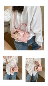 Pink heart embossed glossy patent leather handbag with a plush bear keychain charm