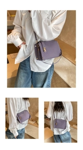 Detail view of lilac faux leather bag with golden twist lock and shoulder strap