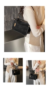 Detail of vintage suede shoulder bag with contrast stitching and golden clasp buckle