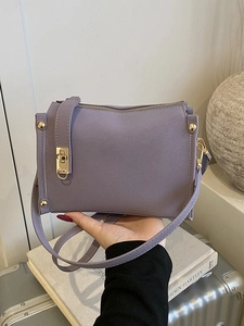 Chic lavender purple shoulder bag with gold square clasp and crossbody strap