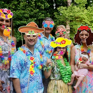 Hawaiian Luau party photo booth props with tropical hats, sunglasses, and drinks