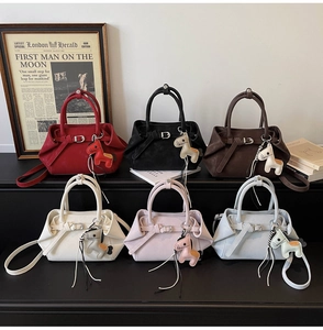 Collection of six pleated tote bags in varied colors with horse charms and matte finish