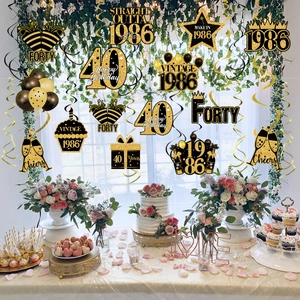 Black and gold 40th birthday swirl decorations with vintage 1986 glitter cardstock cutouts