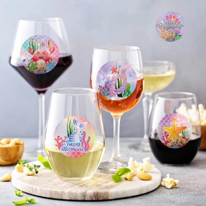 Colorful mermaid birthday party stickers with sea life designs on party drinkware