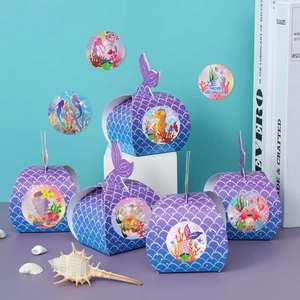 Mermaid party favor boxes with purple scale texture, fish tail handles and ocean stickers