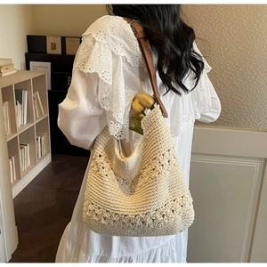 Detail of hand-woven cream tote with leather strap and 3D floral crochet patterns