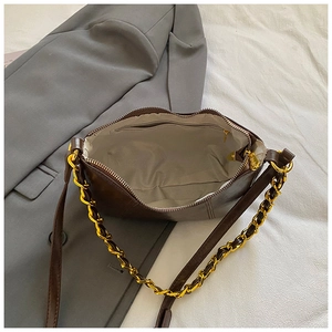 Minimalist dark brown croissant shoulder bag with gold chain and woven lining interior
