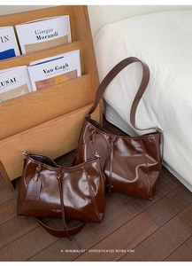 Detail of dark brown faux leather tote and mini pouch with LAZY BREEZE PARIS text