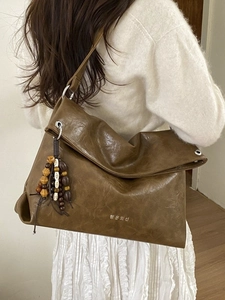 Retro dark brown hobo tote bag with Korean lettering and wooden bead charm on shoulder