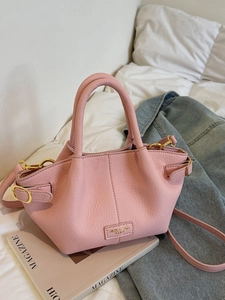Pink lychee textured bucket handbag with gold hardware and adjustable strap for women