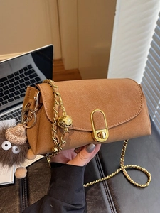 Brown suede crossbody bag with gold chain strap and cute plush charm detail