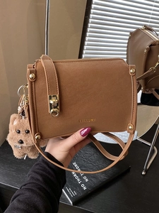 Vintage brown leather crossbody square bag with gold buckle and teddy dog pendant