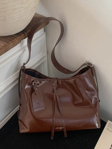 Dark brown large leather tote bag with Lazy Breeze Paris logo and drawstring detail