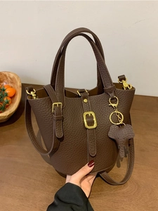 Retro dark brown pebbled leather bucket bag with top handle and elephant charm