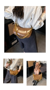 Detail view of brown vintage crescent bag with gold chain strap and smooth oil leather texture