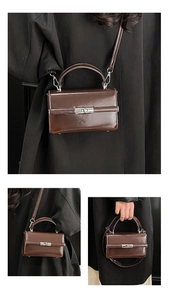 Detail of dark brown leather square handbag showing metallic lock and versatile straps