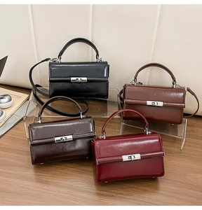 Detail view of glossy leather crossbody bags in four colors with silver rotary metal buckles