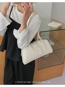 French retro cream Boston bag with fine shoulder strap shown in a lifestyle setting