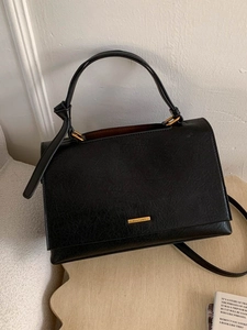Minimalist black cracked texture leather handbag with gold metal hardware and top handle