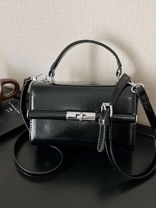 Black glossy patent leather handbag with silver twist lock and adjustable shoulder strap