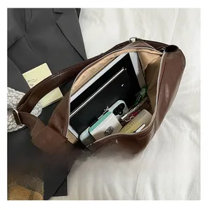 Interior view showing the large capacity of the dark brown PU leather dumpling bag with iPad