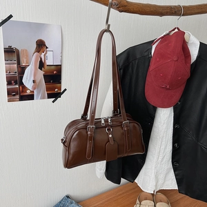 Detail of dark brown vintage Boston bag with silver zippers and smooth leather finish