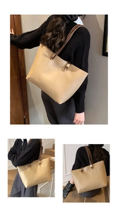 Detail view of khaki faux leather tote bag showing slim brown straps and gold rings