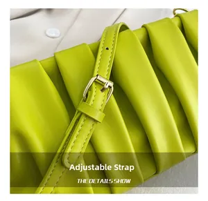 Detail of lime green pleated leather bag featuring adjustable strap and gold-tone hardware