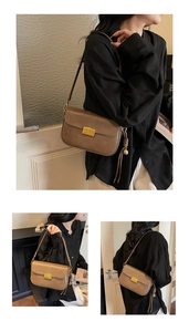 Detail of dark brown leather crossbody bag with golden metal buckle and side tassel