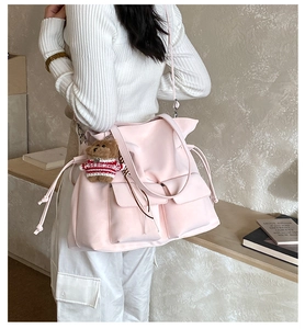 Pink large capacity shoulder bag with utility pockets and a cute teddy bear charm
