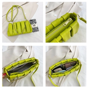 Detail of pleated lime green crossbody bag featuring pearl chain strap and inner pockets