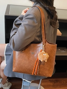 Vintage large brown faux leather tote bag with stylish charms for daily commute