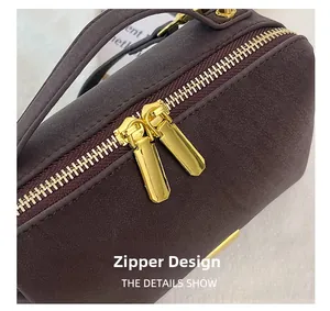 Macro shot of high-quality golden double-sided zipper on dark textured leather bag